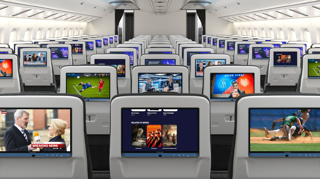 Airplane cabin with rows of seats and in-flight screens displaying various programs