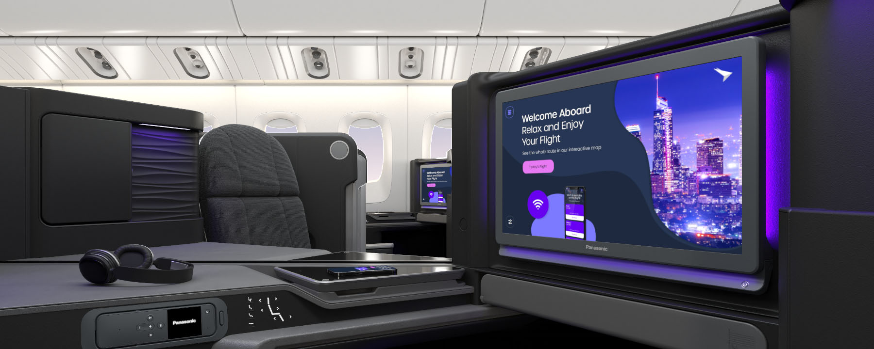 Business class cabin featuring private pods with dark grey seats, personal screens, and overhead bins