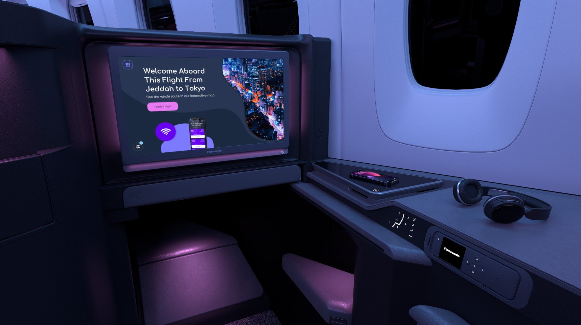Modern airplane business class seat with screen displaying a welcome message for a flight from Jeddah to Tokyo