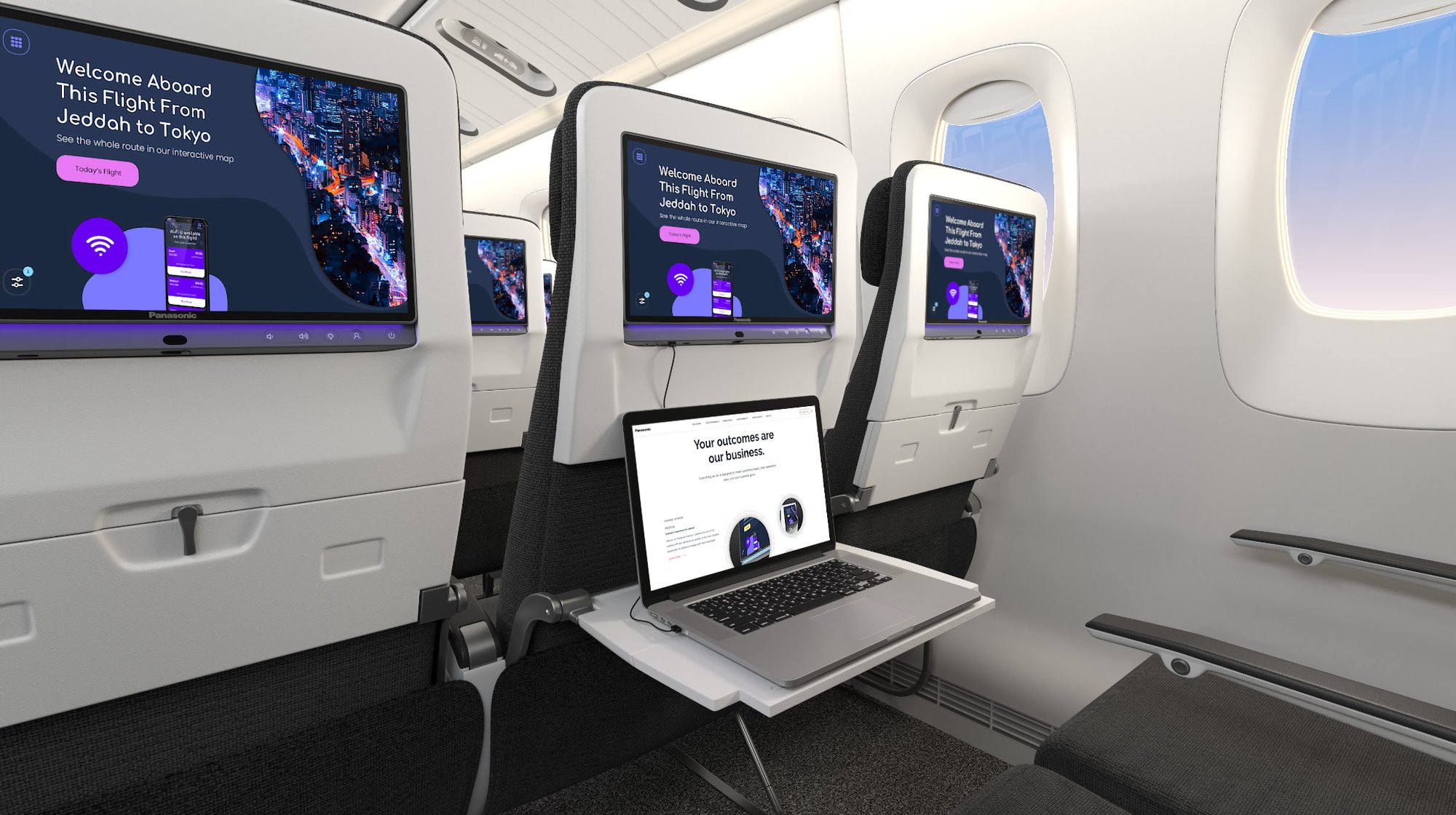 A row of seats in an airline with Astrova screens on the seatbacks, with a laptop plugged into the center screen's USB-C port.