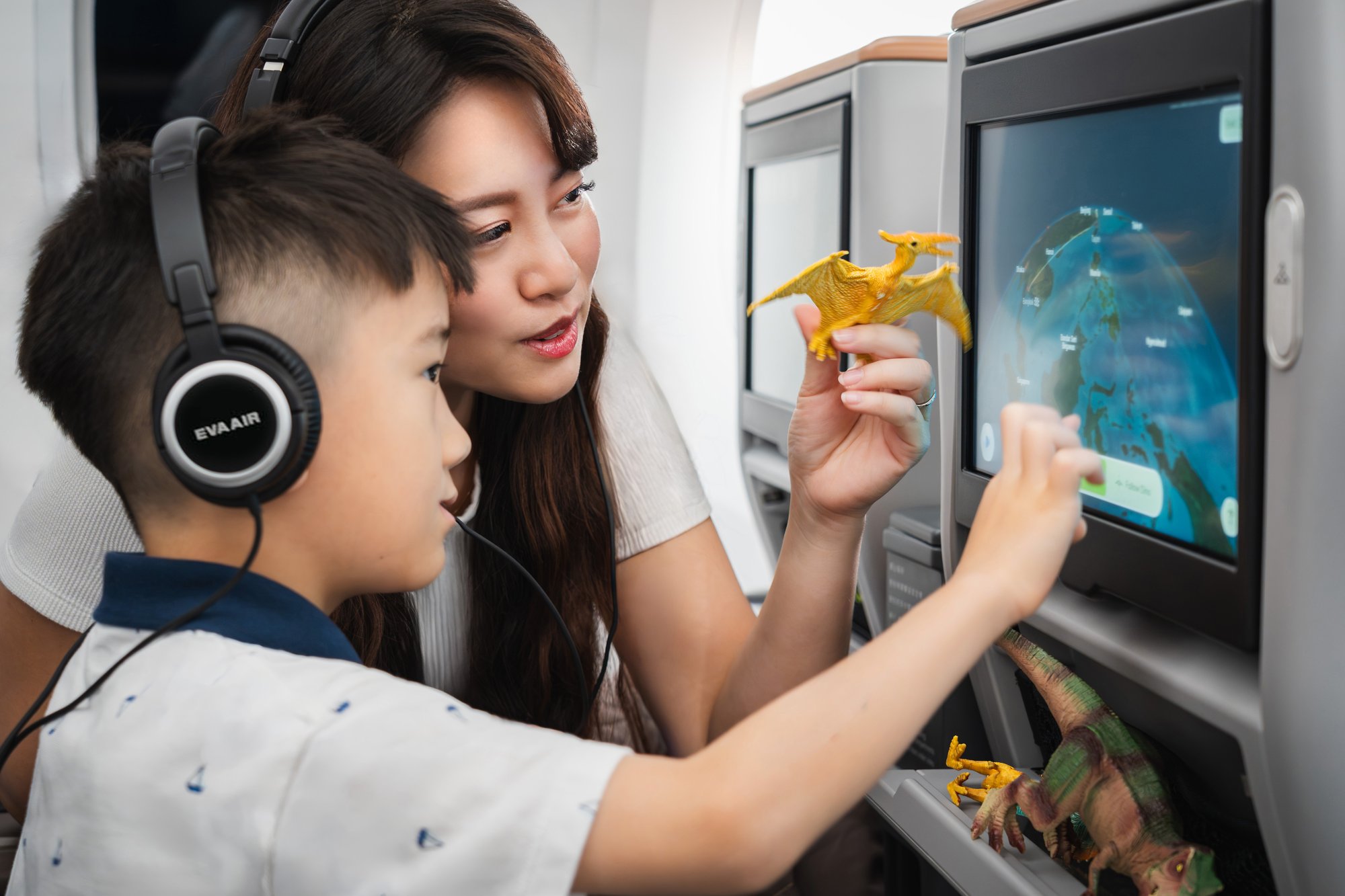 Mother and son interacting with Panasonic Avionics Arc map