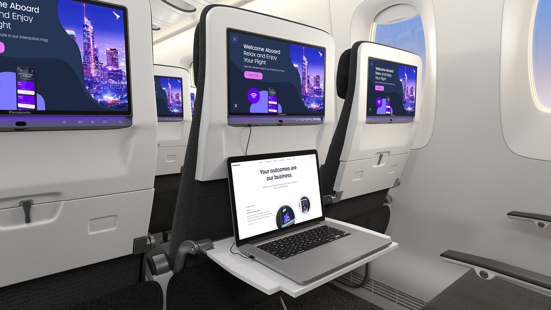 Astrova screens on seat backs in economy class seats with a laptop connected to the fast charging Astrova USB-C port