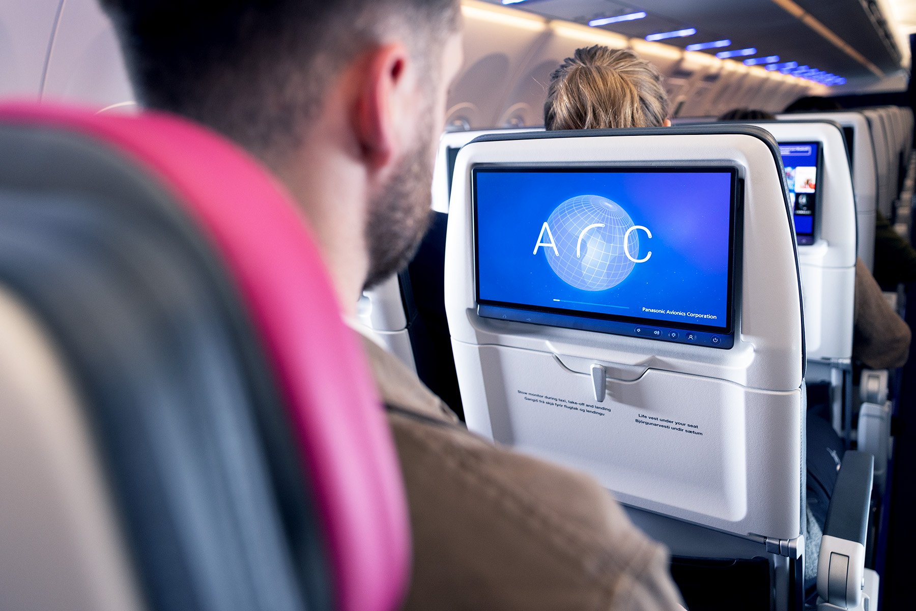 A passenger in an airplane using the Arc feature