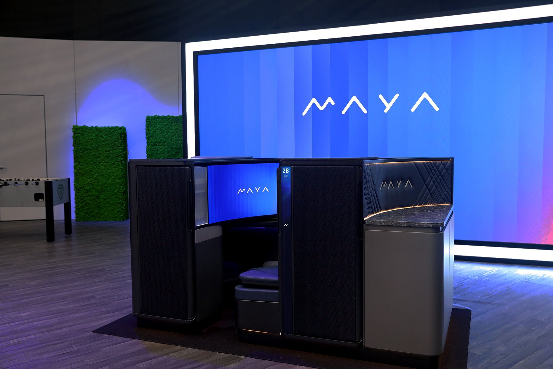 Full left view of the MAYA seat with the word MAYA displayed on the curved screen at AIX