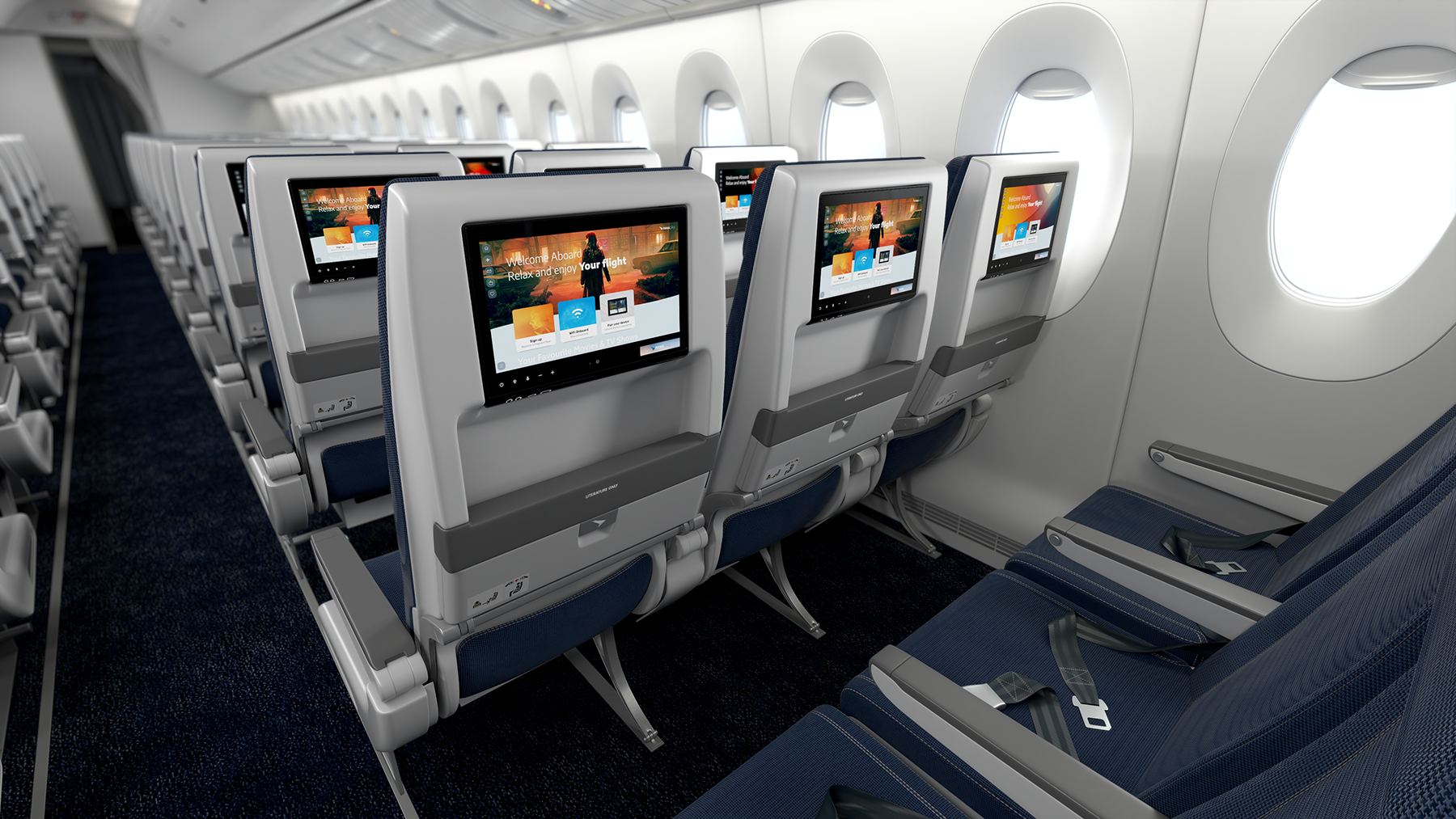 Airplane cabin interior with rows of economy class seats and individual entertainment screens